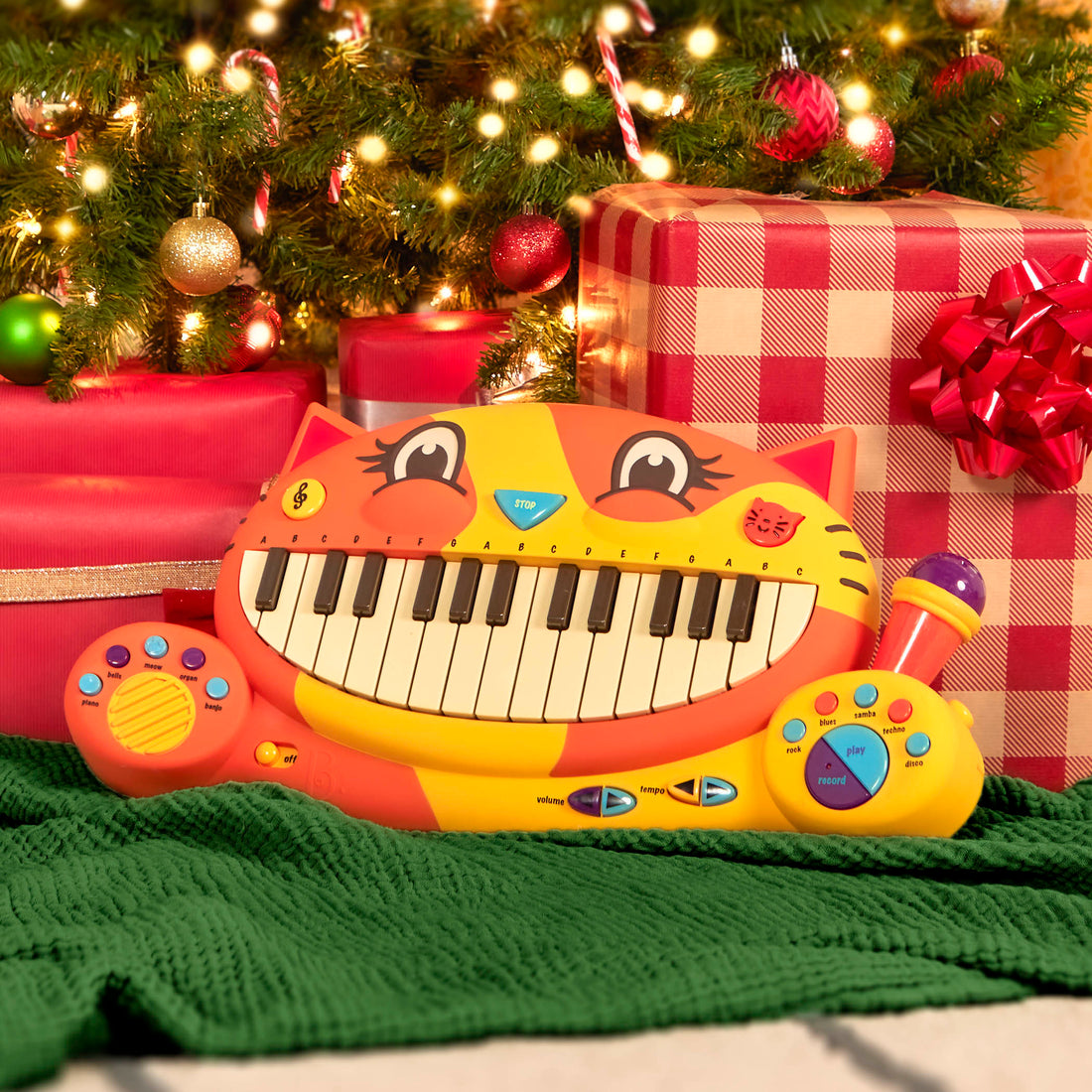 Cat piano under christmas tree with gifts