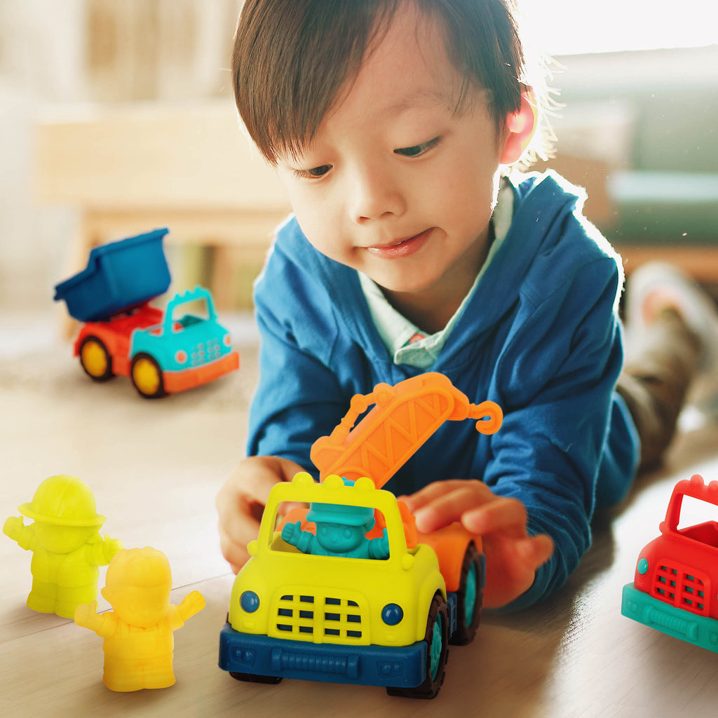 Three toy trucks with drivers.